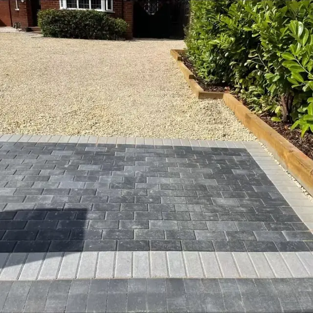 Block paving in contrasting bands beside a gravelled area