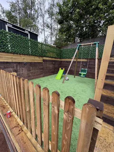 A picket fence built around a play area