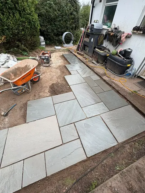 A patio going in, with the base prepared and slabs being laid