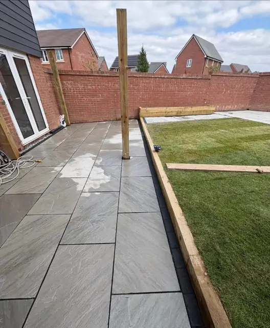 A long slab path down the side of a house with timber edging